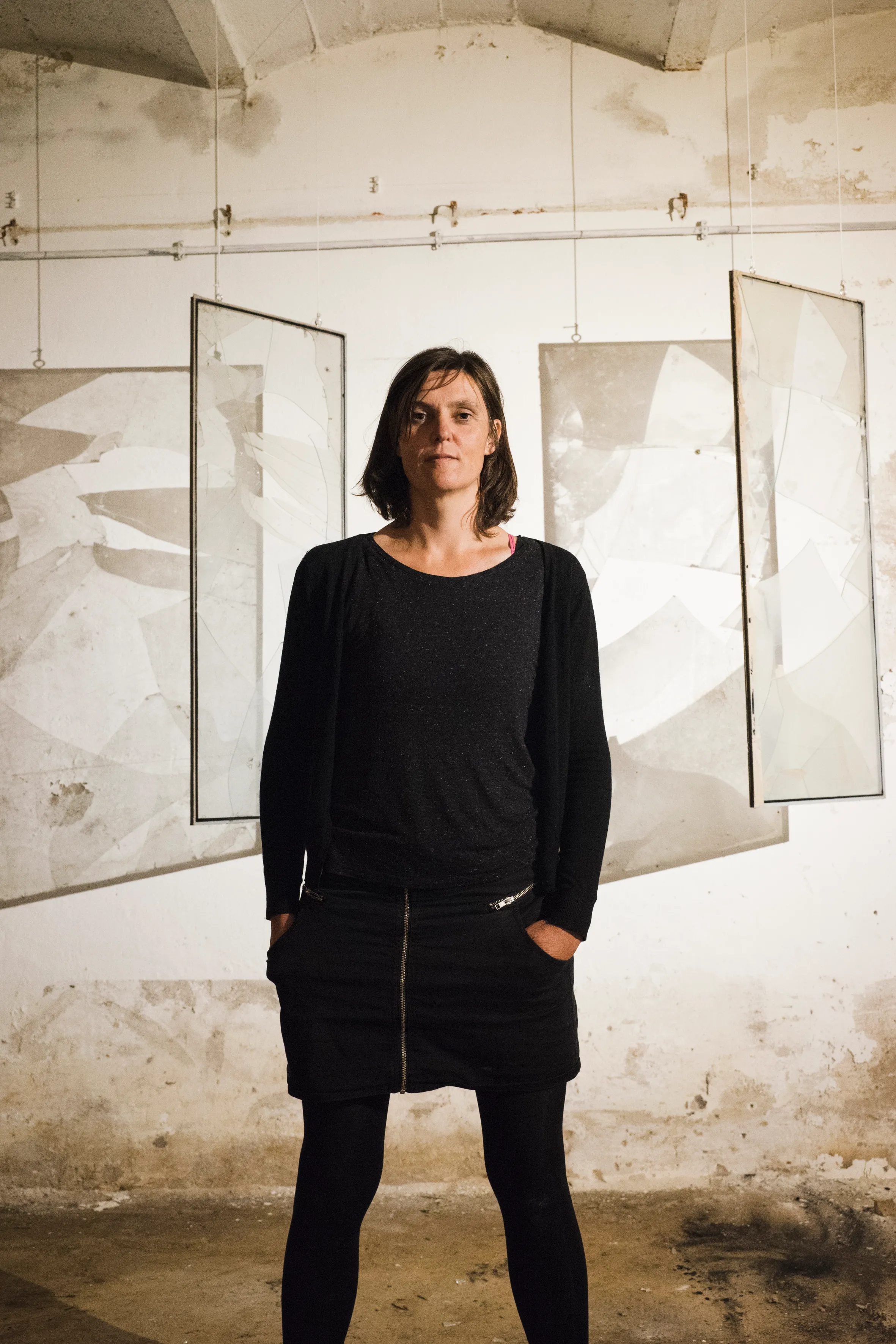 Portrait of an artist before suspended glass works